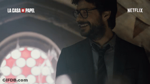 A Man In A Suit And Tie Is Smiling In Front Of A Window With The Words La Casa De Papel On The Bottom GIF