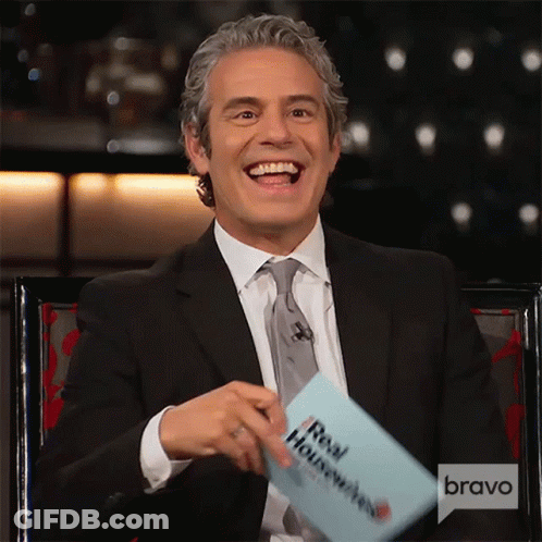 Smiling Man In Suit Holding Housewives Card GIF