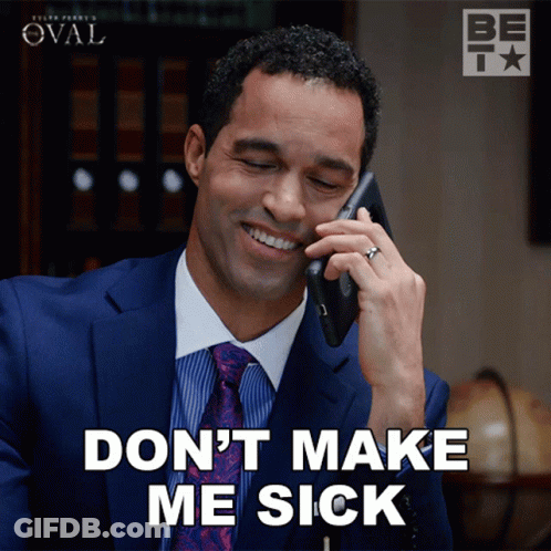 A Man In A Suit And Tie Is Smiling While Talking On A Cell Phone GIF