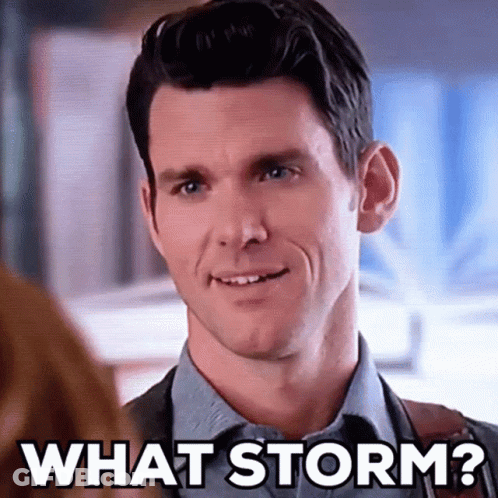 A Man In A Suit And Tie Is Smiling While Talking To A Woman And Says `` What Storm ? '' GIF