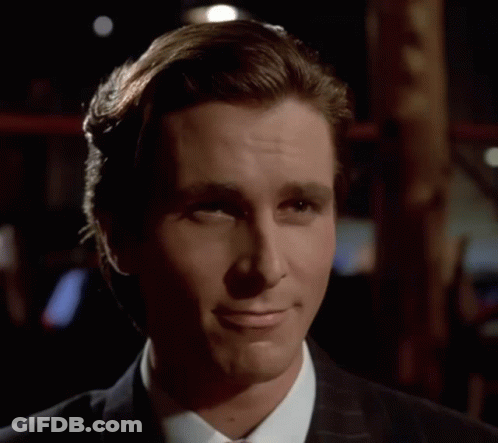 A Man In A Suit And Tie Is Smiling With His Eyes Closed GIF