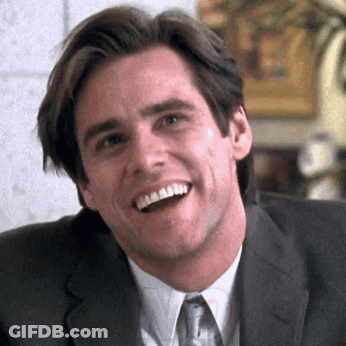 A Man In A Suit And Tie Is Smiling With His Mouth Wide Open GIF