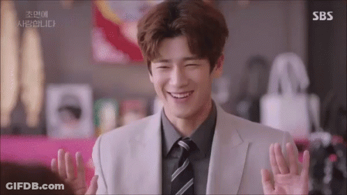 A Man In A Suit And Tie Is Smiling With Sbs Written On The Bottom GIF