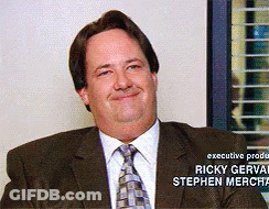 A Man In A Suit And Tie Is Smiling With The Name Ricky Gervais On The Bottom GIF