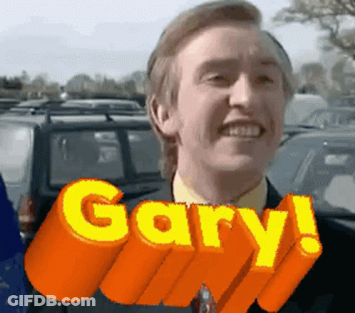 A Man In A Suit And Tie Is Smiling With The Word Gary Above Him GIF