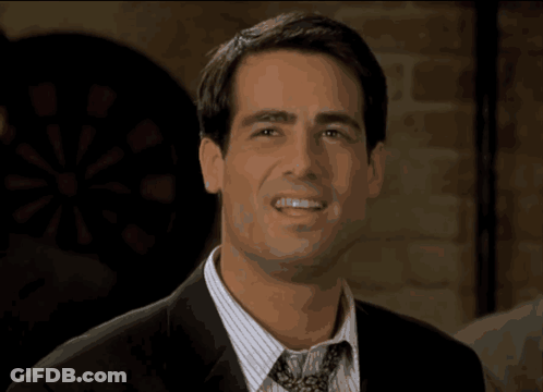 A Man In A Suit And Tie Is Smiling With The Word Prove It Behind Him GIF