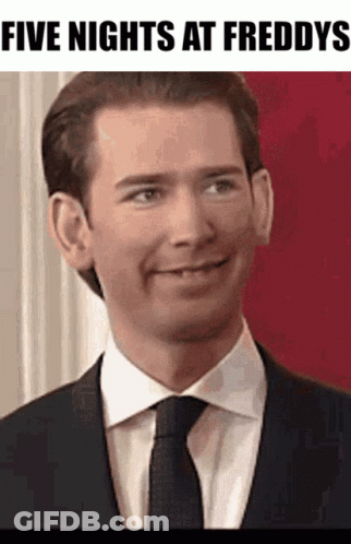 A Man In A Suit And Tie Is Smiling With The Words Five Nights At Freddys Below Him GIF