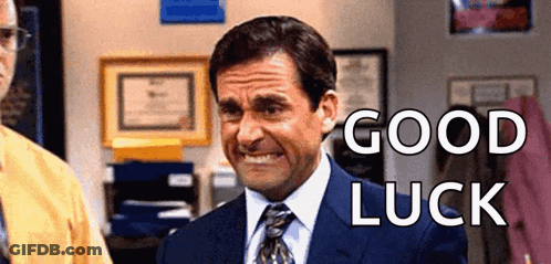 A Man In A Suit And Tie Is Smiling With The Words `` Good Luck '' Behind Him . GIF