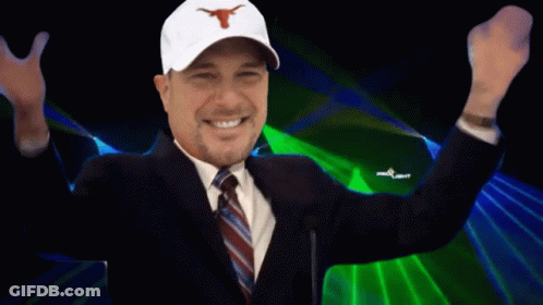 A Man In A Suit And Tie Is Smiling With The Words It 'S Hermaning Behind Him GIF