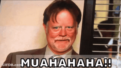 A Man In A Suit And Tie Is Smiling With The Words Muahaha Written Below Him GIF