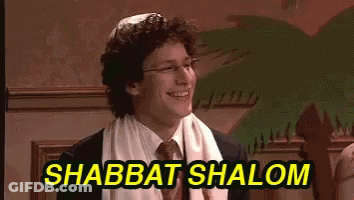 A Man In A Suit And Tie Is Smiling With The Words Shabbat Shalom Above Him GIF