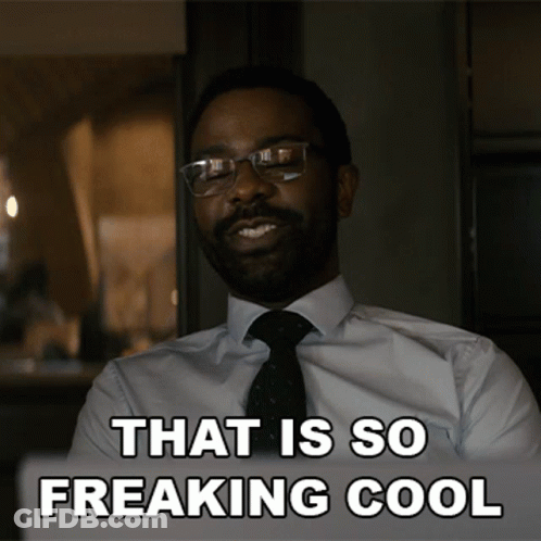 A Man In A Suit And Tie Is Smiling With The Words That Is So Freaking Cool Below Him GIF