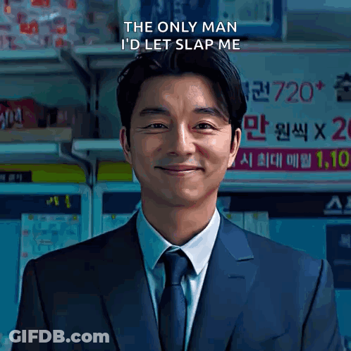 A Man In A Suit And Tie Is Smiling With The Words The Only Man I 'D Let Slap Me Above Him GIF