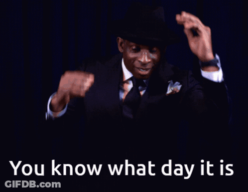 A Man In A Suit And Tie Is Smiling With The Words " You Know What Day It Is " Below Him GIF