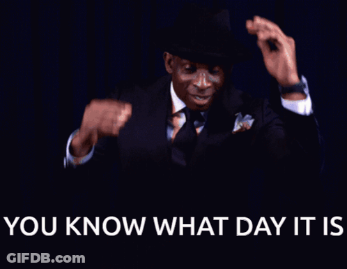 A Man In A Suit And Tie Is Smiling With The Words " You Know What Day It Is " Below Him GIF