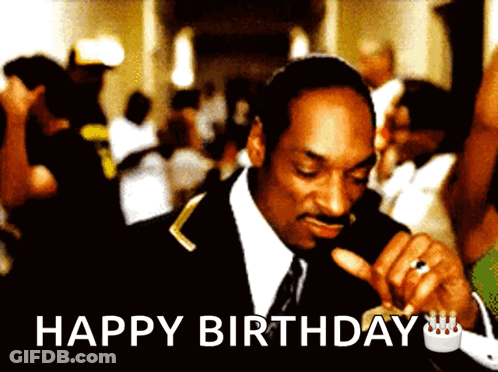 A Man In A Suit And Tie Is Smoking A Cigarette With The Words Happy Birthday Below Him GIF