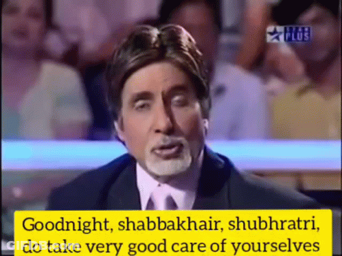 A Man In A Suit And Tie Is Speaking In Front Of A Crowd GIF
