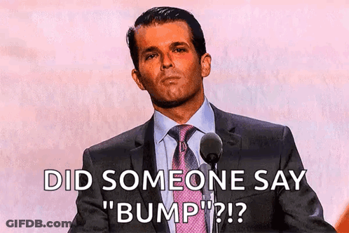 A Man In A Suit And Tie Is Speaking Into A Microphone And Says Did Someone Say " Bump " GIF