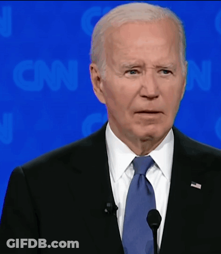 A Man In A Suit And Tie Is Speaking Into A Microphone In Front Of A Cnn Background GIF