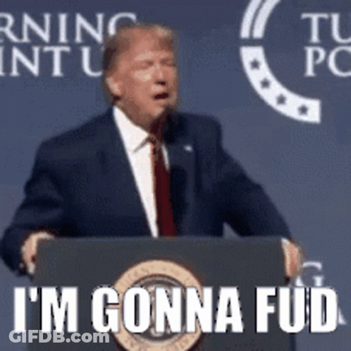 A Man In A Suit And Tie Is Standing At A Podium And Says I 'M Gonna Fud . GIF