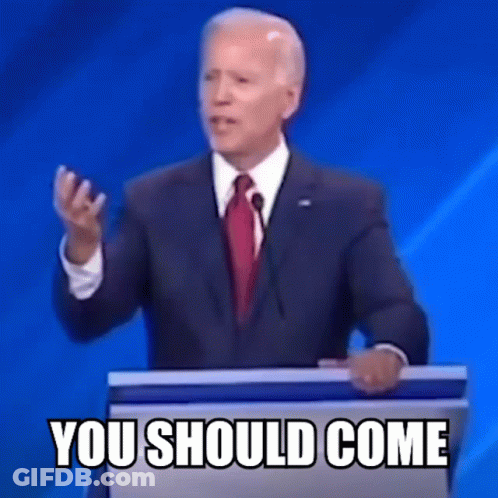 A Man In A Suit And Tie Is Standing At A Podium Giving A Speech And Says You Should Come . GIF