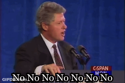 A Man In A Suit And Tie Is Standing At A Podium Talking Into A Microphone And Saying No No No No No No No GIF