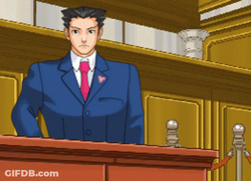 A Man In A Suit And Tie Is Standing Behind A Podium GIF