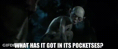 A Man In A Suit And Tie Is Standing In A Cave And Asking What Has It Got In Its Pockets ? GIF