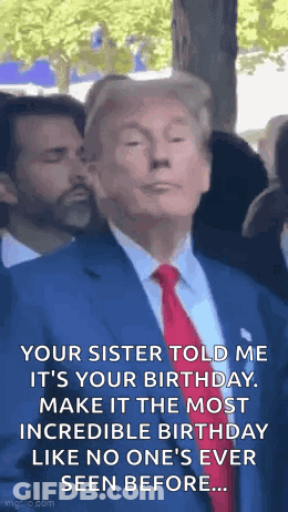 A Man In A Suit And Tie Is Standing In A Crowd . GIF