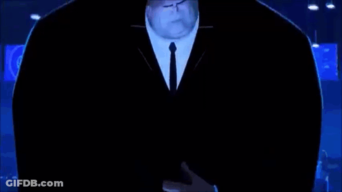 A Man In A Suit And Tie Is Standing In A Dark Room With A Globe In The Background . GIF