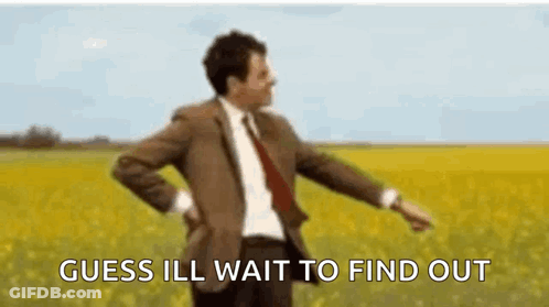 A Man In A Suit And Tie Is Standing In A Field Of Yellow Flowers . GIF