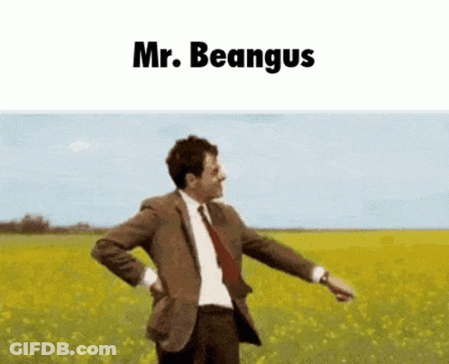 A Man In A Suit And Tie Is Standing In A Field With The Words Mr. Beangus Above Him GIF