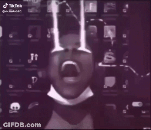 A Man In A Suit And Tie Is Standing In A Foggy Room With A Lightning Bolt Behind Him . GIF
