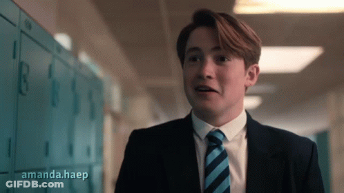 A Man In A Suit And Tie Is Standing In A Hallway With Amanda.haep Written On The Bottom Right GIF