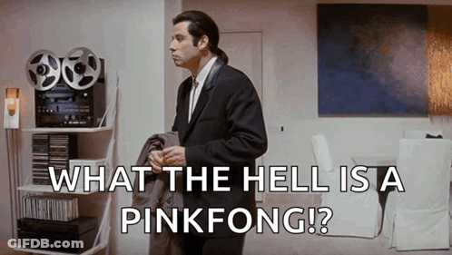 A Man In A Suit And Tie Is Standing In A Living Room With The Words What The Hell Is A Pinkfong .. GIF