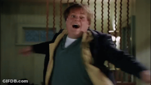 A Man In A Suit And Tie Is Standing In A Room With A Fence In The Background . GIF