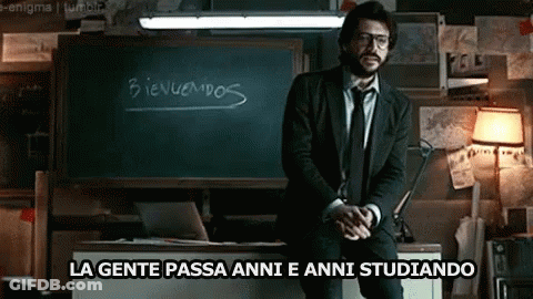 A Man In A Suit And Tie Is Standing In Front Of A Blackboard That Says Bienvenidos GIF