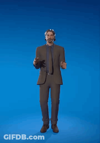 A Man In A Suit And Tie Is Standing In Front Of A Blue Background . GIF