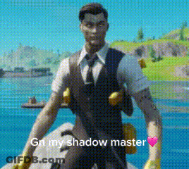 A Man In A Suit And Tie Is Standing In Front Of A Body Of Water Holding A Gun . GIF