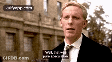 A Man In A Suit And Tie Is Standing In Front Of A Building And Says Well , That Was Pure Speculation . GIF