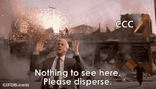 A Man In A Suit And Tie Is Standing In Front Of A Building That Is On Fire And Says Nothing To See Here Please Disperse GIF