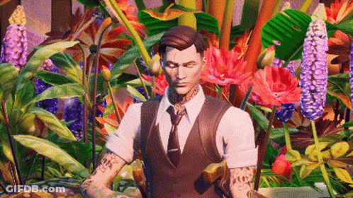 A Man In A Suit And Tie Is Standing In Front Of A Bunch Of Flowers . GIF