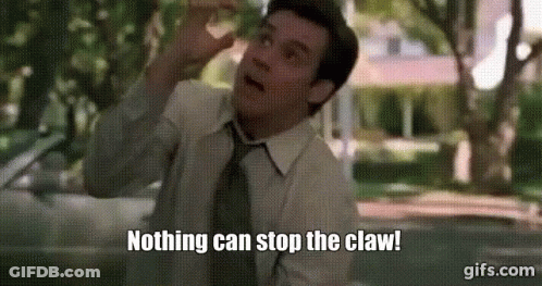 A Man In A Suit And Tie Is Standing In Front Of A Car And Saying `` Nothing Can Stop The Claw '' . GIF