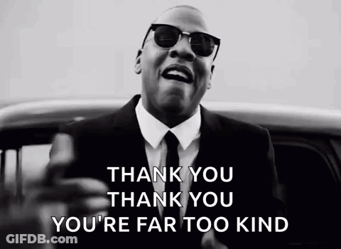 A Man In A Suit And Tie Is Standing In Front Of A Car And Singing . GIF