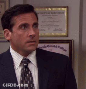 A Man In A Suit And Tie Is Standing In Front Of A Certificate Of Achievement GIF