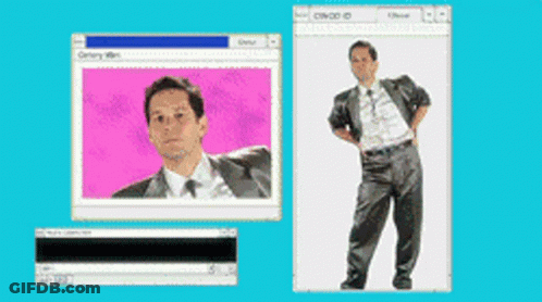 A Man In A Suit And Tie Is Standing In Front Of A Computer Screen GIF
