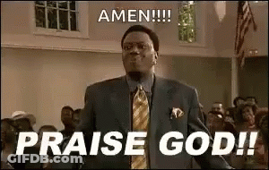 A Man In A Suit And Tie Is Standing In Front Of A Crowd And Saying Amen !!! Praise God ! GIF