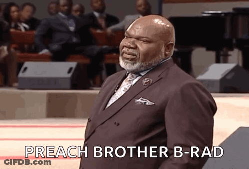 A Man In A Suit And Tie Is Standing In Front Of A Crowd And Saying Preach Brother B-Rad GIF