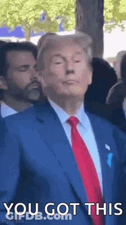 A Man In A Suit And Tie Is Standing In Front Of A Crowd And Saying `` You Got This '' . GIF