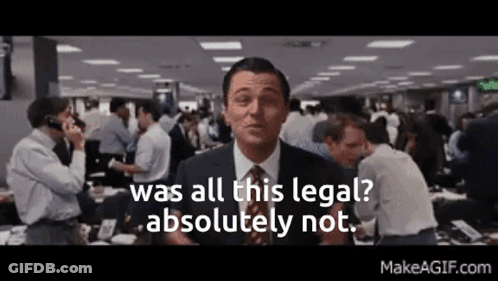 A Man In A Suit And Tie Is Standing In Front Of A Crowd Of People . GIF